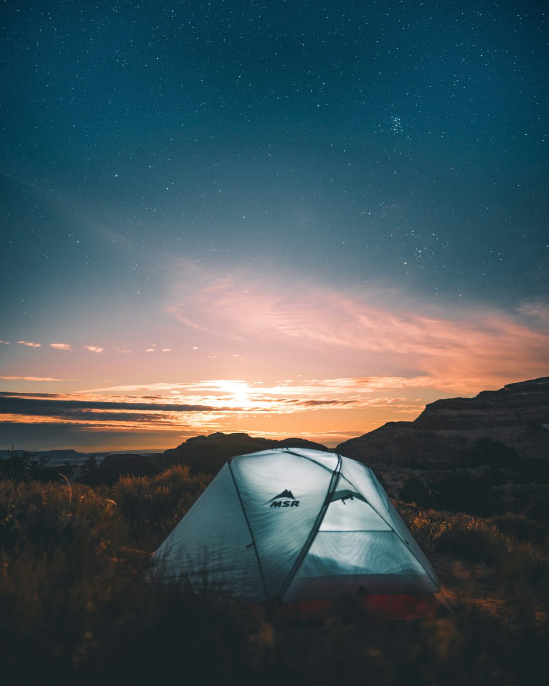 Tent glowing beneath an evening sky
